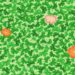 Teste visual com trevo de quatro folhas escondido entre folhas verdes e flores coloridas
