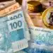 Notas de real e uma moeda, ilustrando a renegociação de dívidas e a chance de limpar o nome em um mutirão especial dos bancos a partir de 1º de novembro.