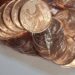 Coleção de moedas de cinco centavos brasileiras empilhadas mostrando diferentes anos de fabricação