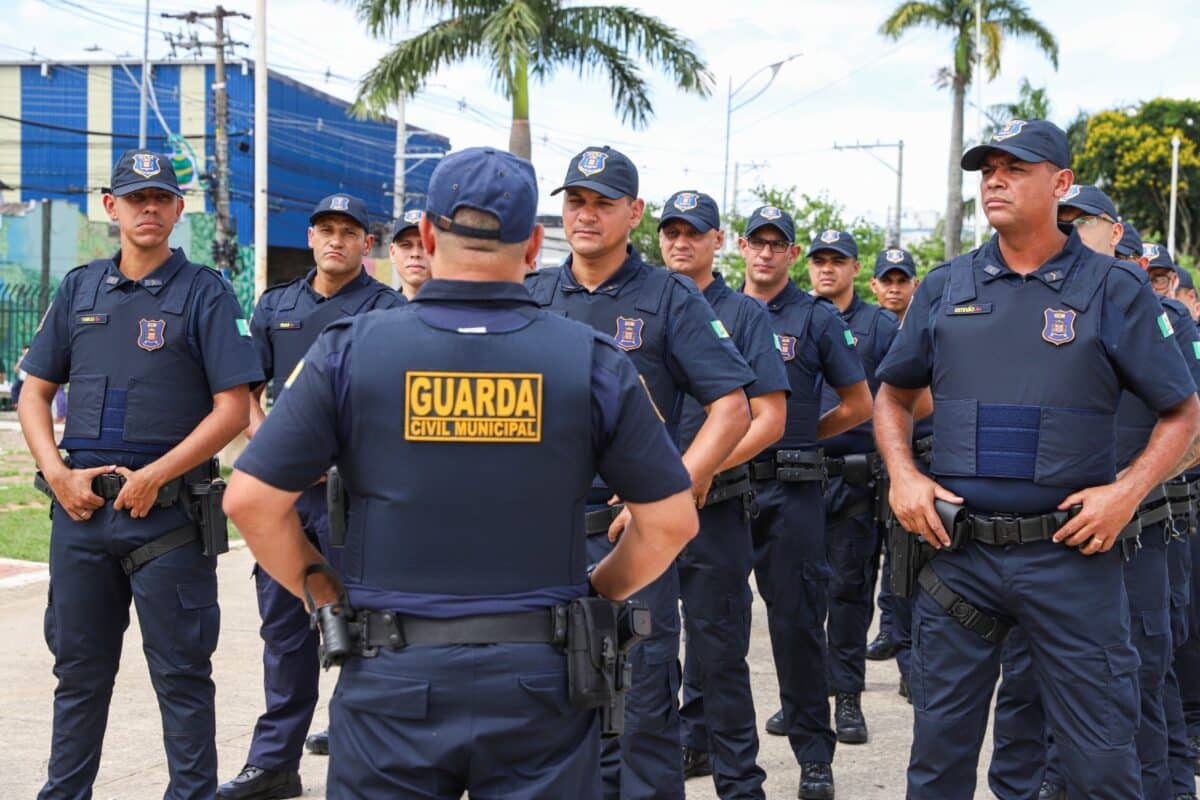 Grupo de agentes da Guarda Civil Municipal uniformizados reunidos em área urbana