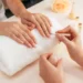 Profissional realiza serviço de manicure durante atendimento em salão de estética.