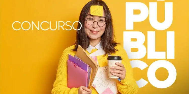 Jovem de suéter amarelo com óculos e post-it na testa segura pastas, cadernos e copo de café.