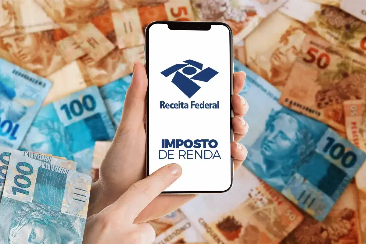 Pessoa consultando restituição do Imposto de Renda pelo celular com notas de real ao fundo